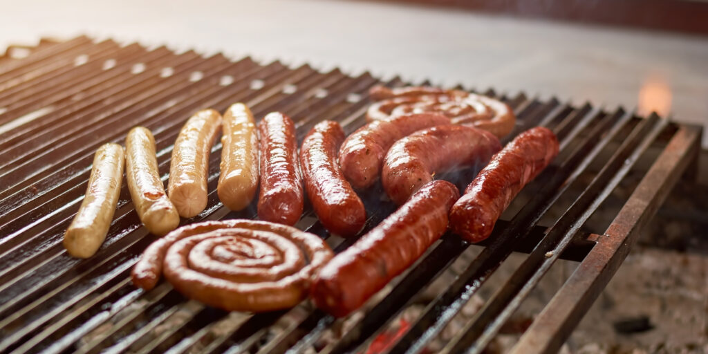 Sausages on grill for barbecue.